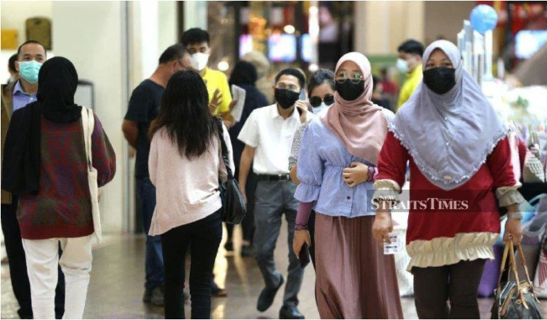 This file pic dated March 30, 2021, shows people wearing face mask while adhering to the SOP at a mall in Kuching. -NSTP/NADIM BOKHARI
